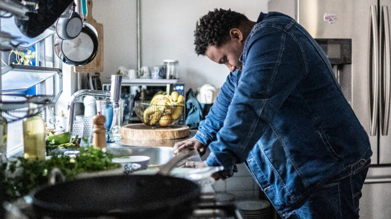 Stressed person leaning on countertop