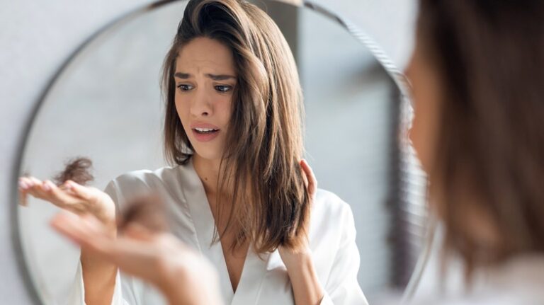 woman holding clump of hair