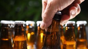 Hand grabbing beer bottle