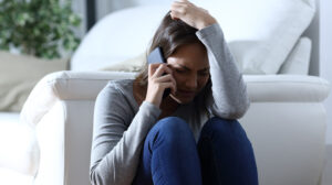 upset woman making a phone call