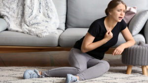 Person on floor struggling to breath