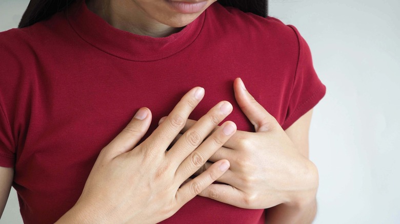 Woman with hands on heart