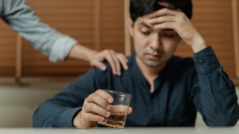 friend consoling man drinking alcohol
