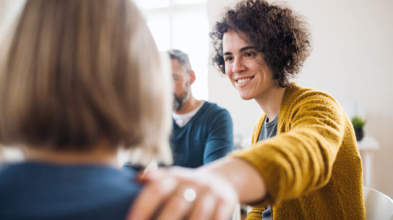 Woman putting hand on shoulder