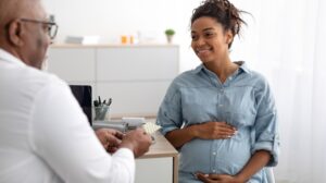 Doctor talking to pregnant person