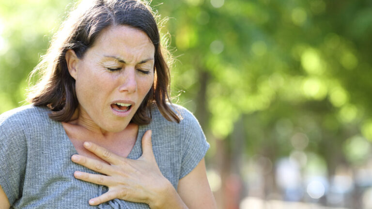 woman holding her chest