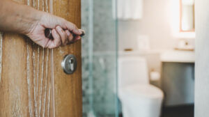 Hand opening wooden bathroom door