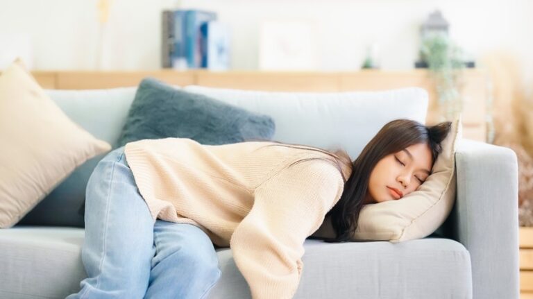 exhausted woman laying in a couch