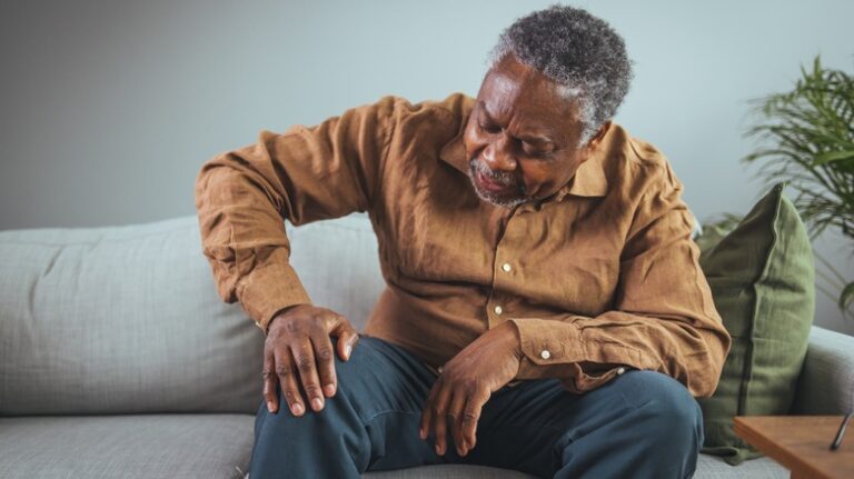 Man holding knee in pain