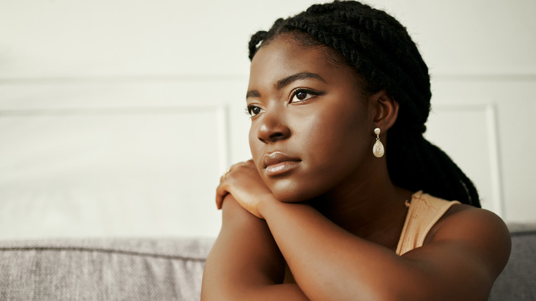 younger woman staring blankly off camera