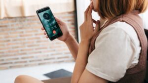 women nervously checks phone