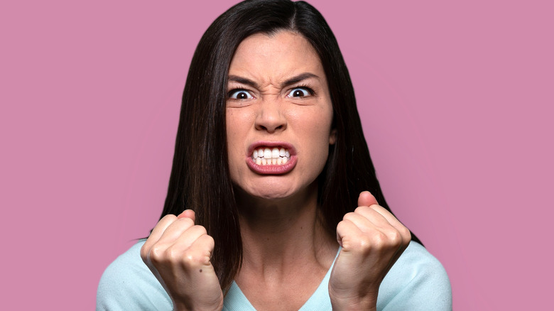 Angry woman with clenched fists