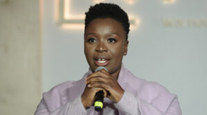 Folake Olowofoyeku speaking into a mic