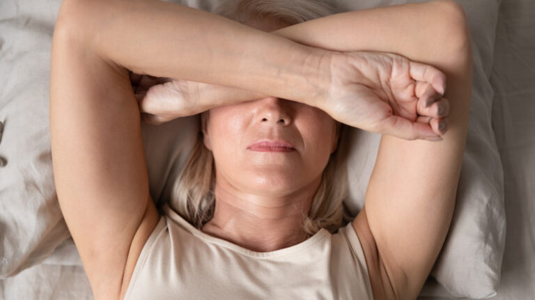 Woman with insomnia lying in bed