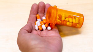 man holding medication in hand