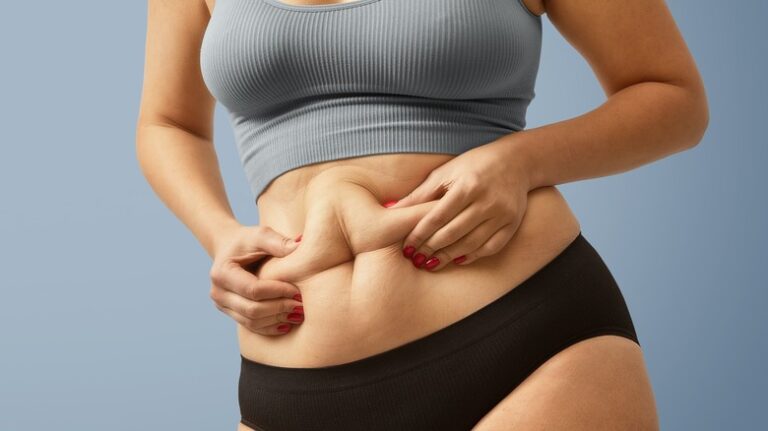 Woman pinching her belly fat