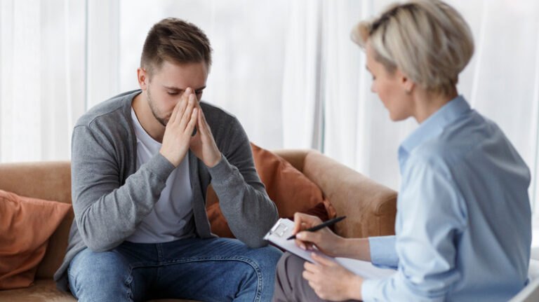 sad man talking with therapist