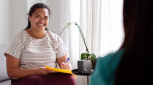 Smiling therapist speaking to patient