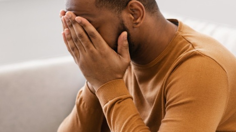 Man with face in hands