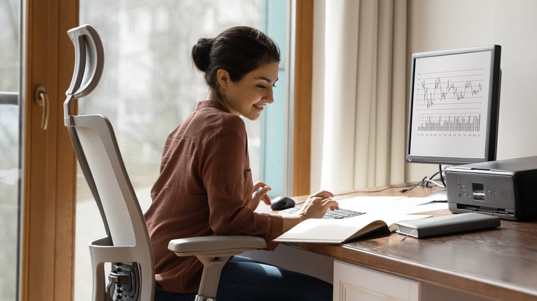 woman working at a desk with a comfortable chair