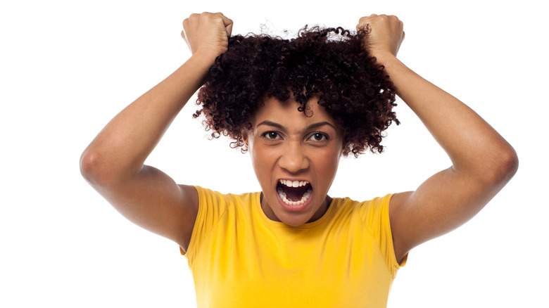 stressed out woman pulling at her hair 