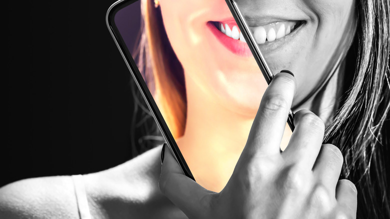 girl using phone to mask face