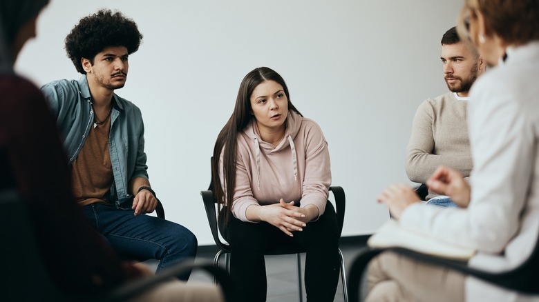 People sitting in group therapy session