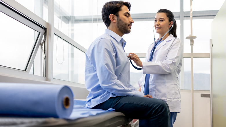 Doctor listening to heart 