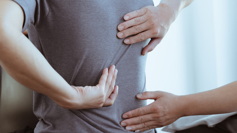 Doctor examining back pain 