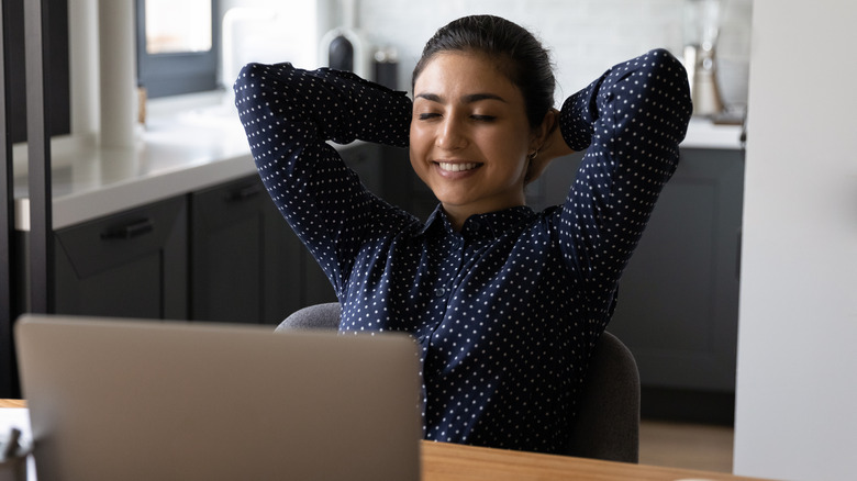 Calm woman stretching at desk