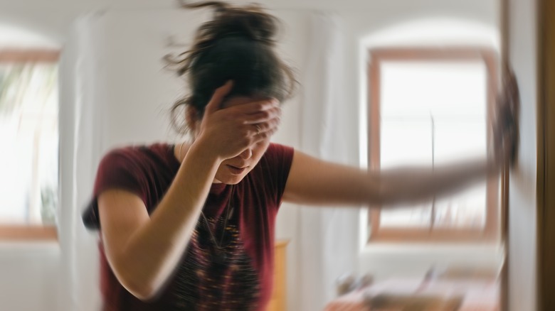 Dizzy woman against a blurry background