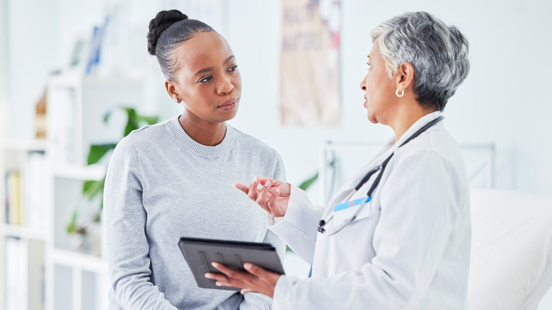 doctor explaining to patient how anxiety affects cholesterol