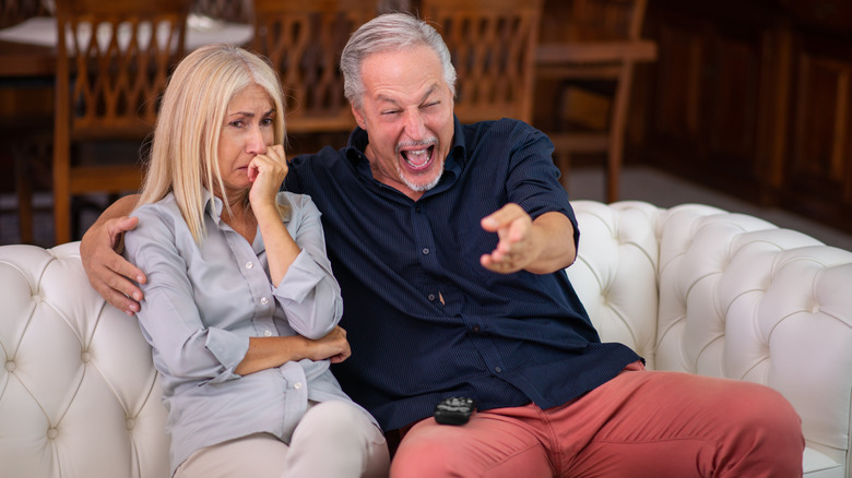 Laughing man with upset woman