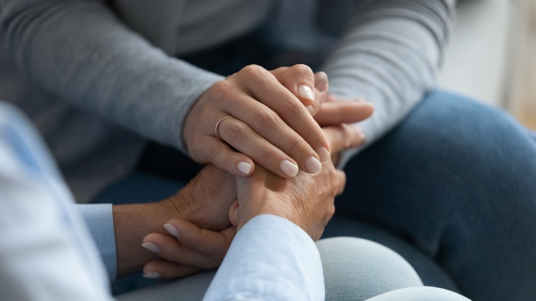family members holding hands 