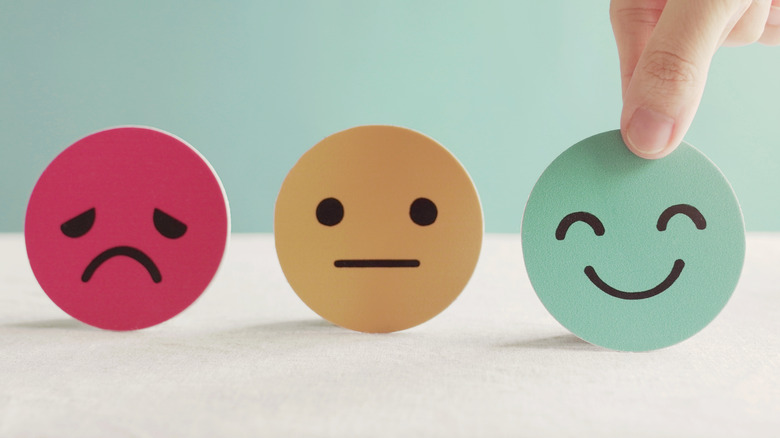 hand with paper faces