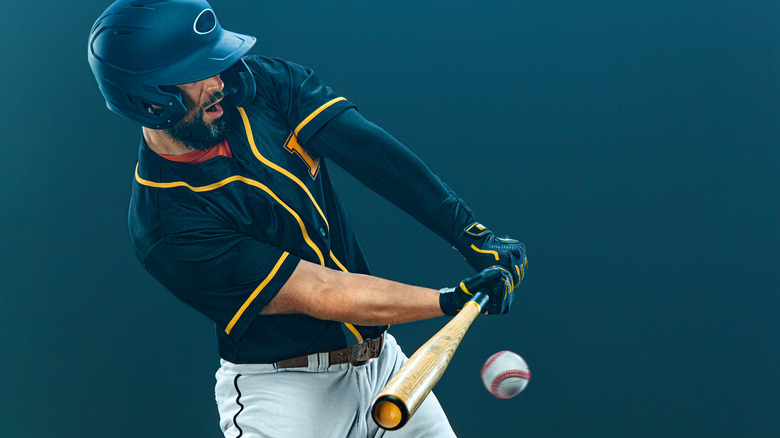 Baseball player hitting ball