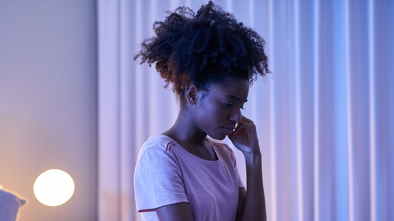 Woman with insomnia sitting on bed