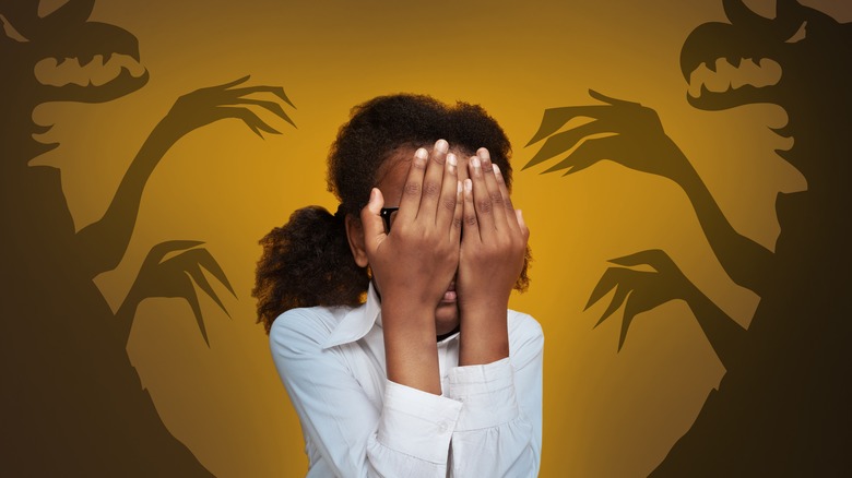 girl surrounded by shadow monsters