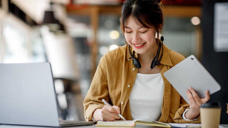 student writing in book