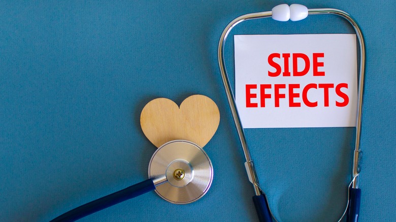 stethoscope and white card with side effects written on it