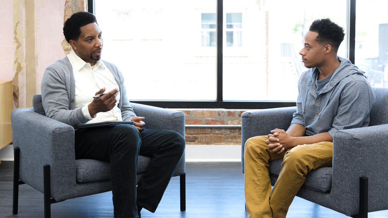 Young man speaking to counselor