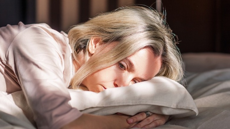 Woman struggling to fall asleep