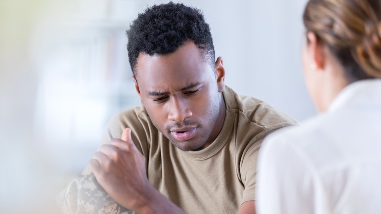 African American man speaks to counselor