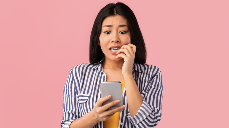 Woman biting her fingernails 