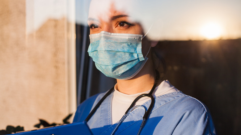 doctor looking through window