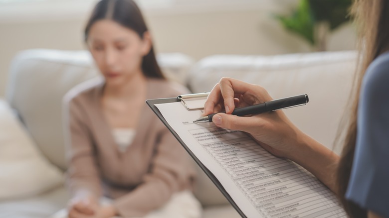 Asian woman talking with therapist