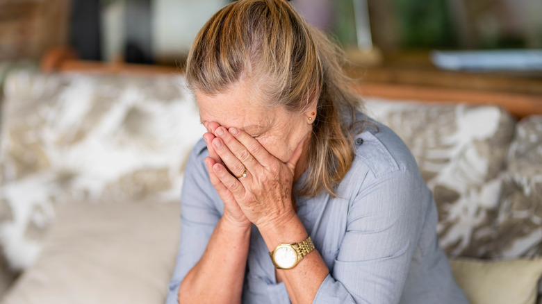 older woman sitting on sofa