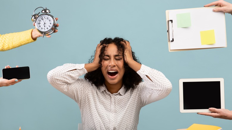woman screams surrounded by overwhelming work