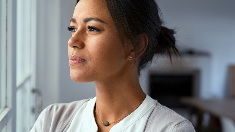 woman with anxiety staring out window
