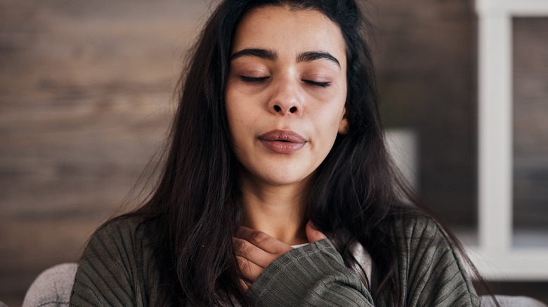 Anxious woman taking a breath